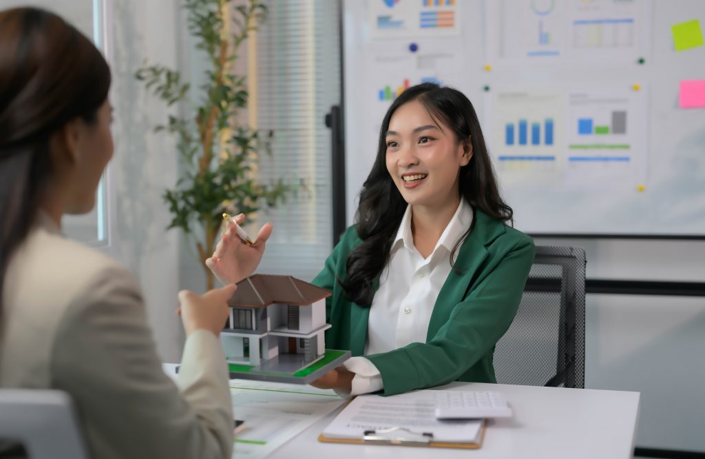 Real Estate Agent Discussing Property with Client in Modern Office Setting